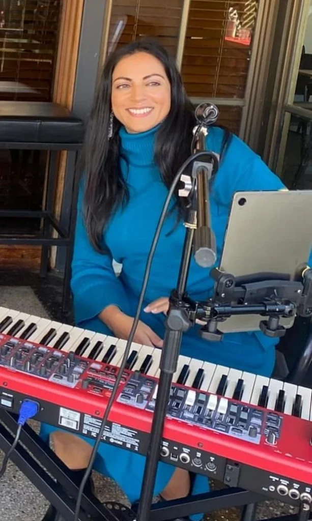 Colleen, founder of Hertz2Hearts, performing at her keyboard
